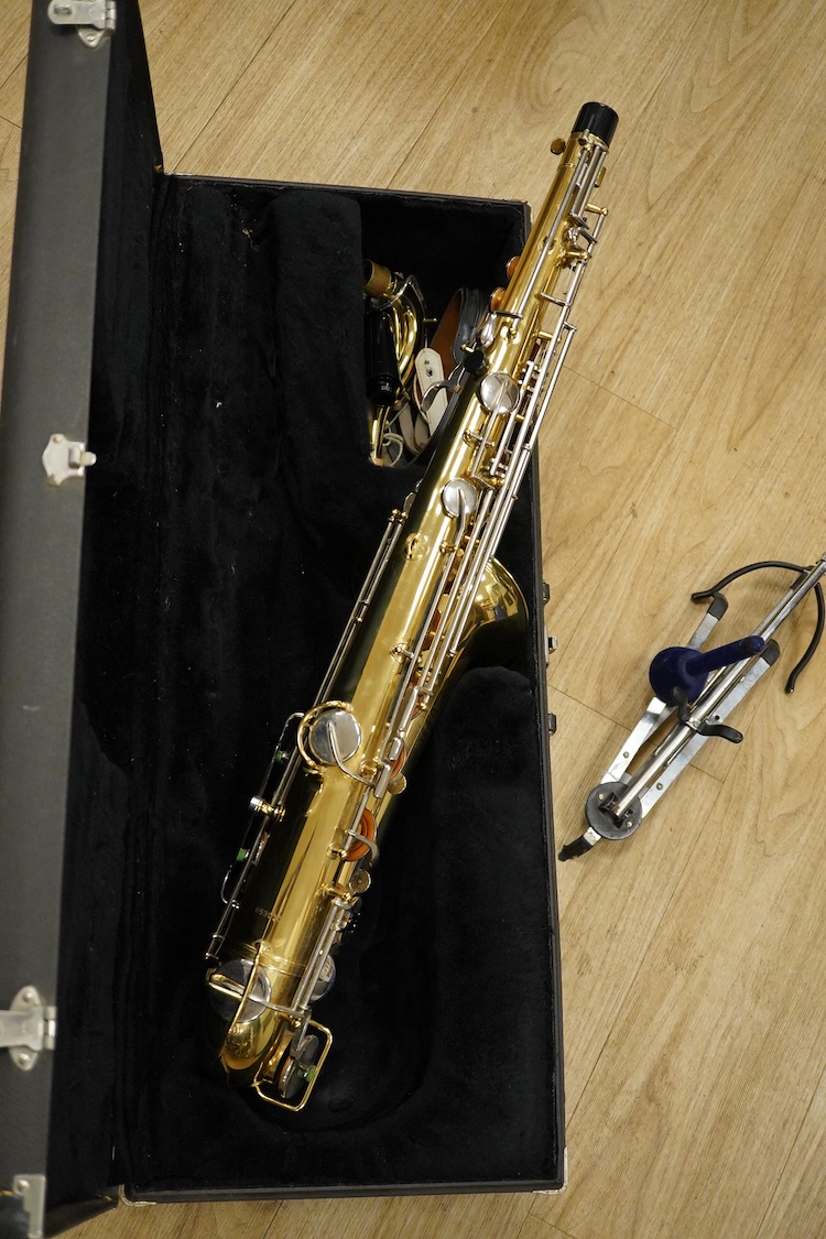 A cased Buescher Aristocrat tenor saxophone and stand